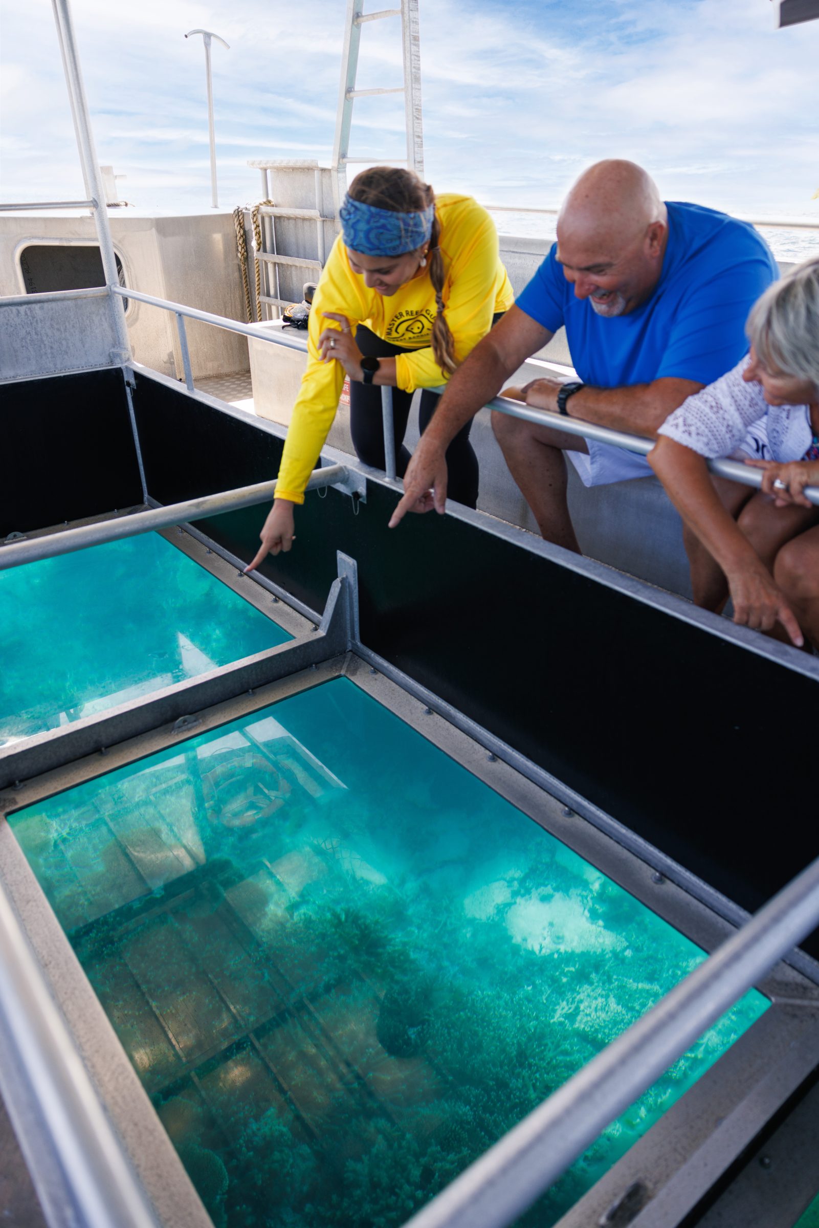 Jessica pointing out marine life to guests on a boat